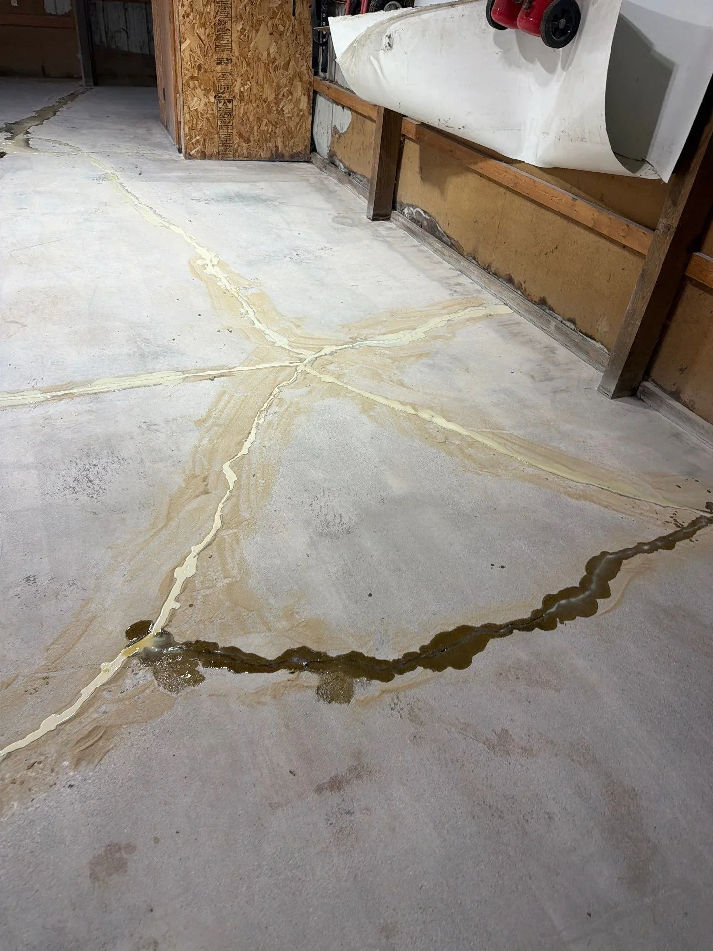 Garage concrete floor with epoxy crack repair injection along multiple fissures