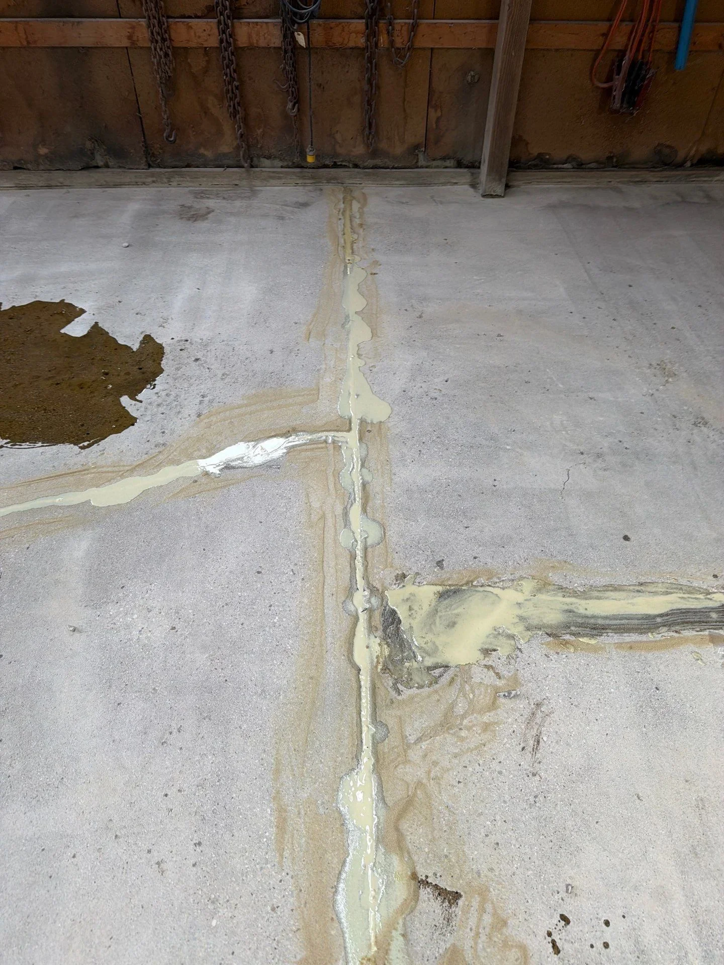 Concrete floor with sealed crack repair using epoxy filler compound
