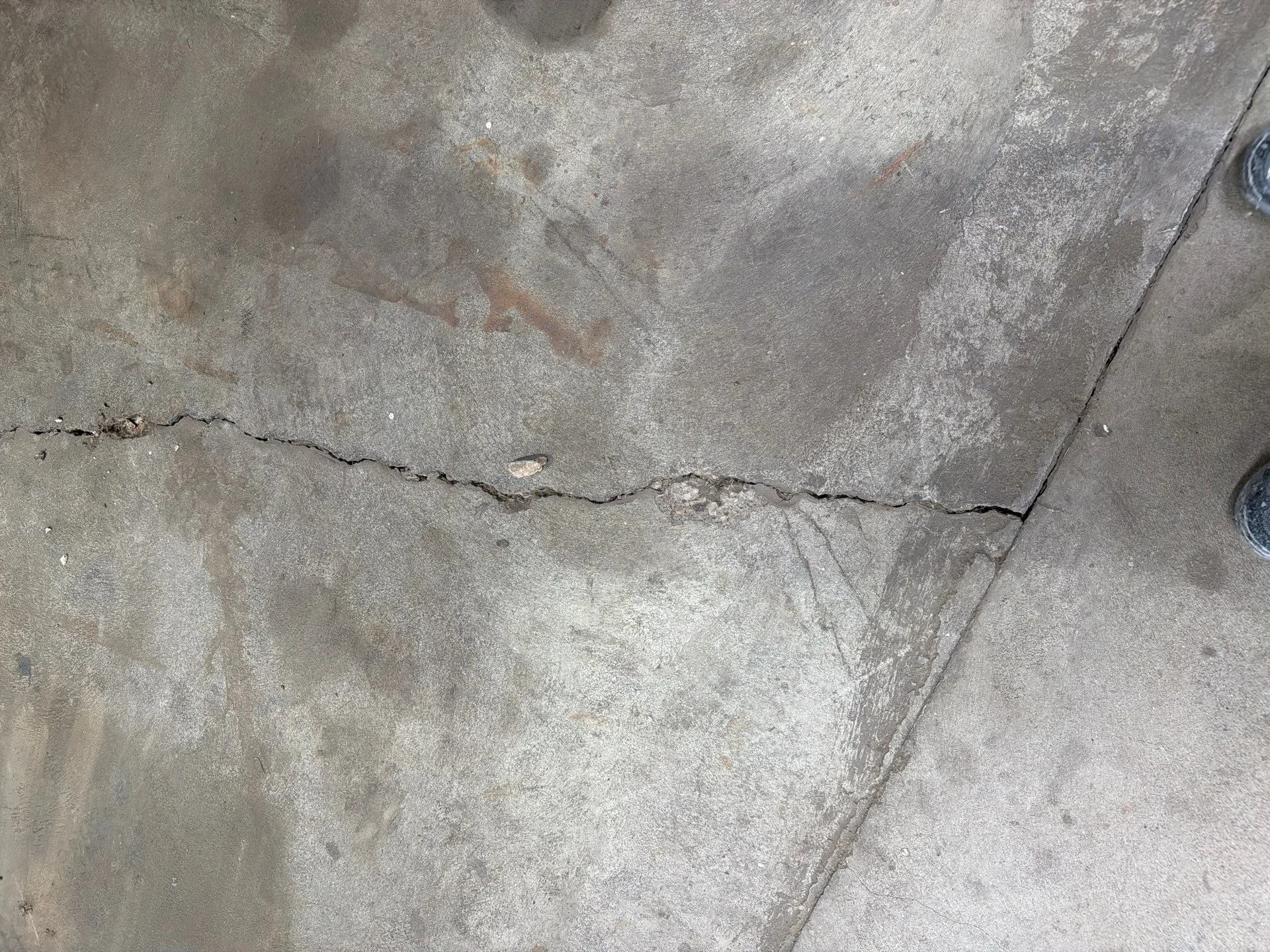 Concrete surface with repaired horizontal crack and leveled sections