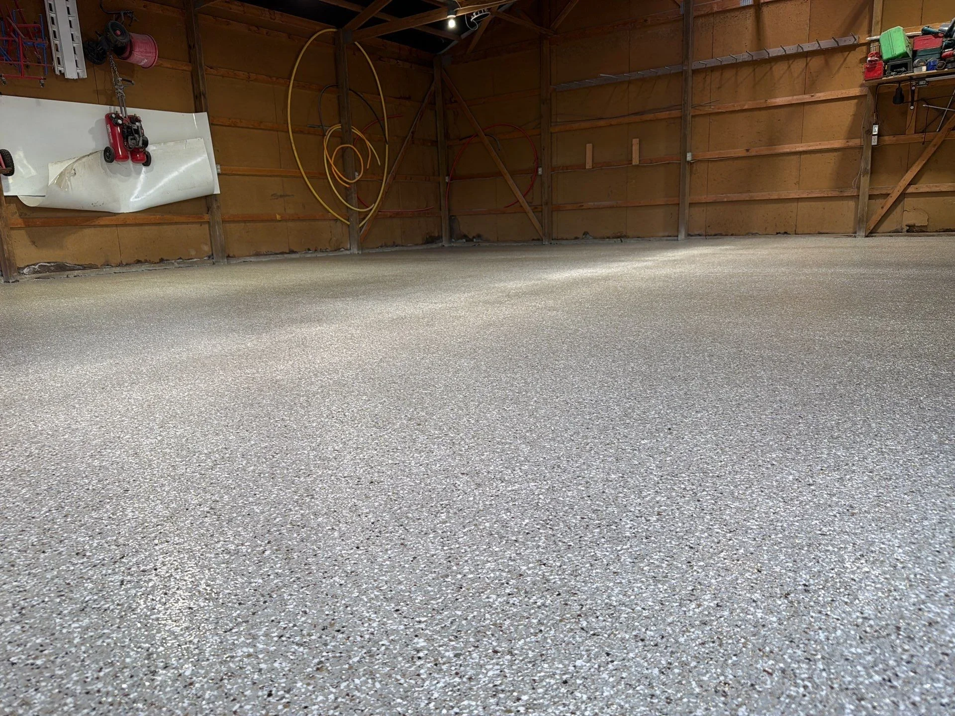 Finished garage floor with light gray epoxy coating and aggregate finish