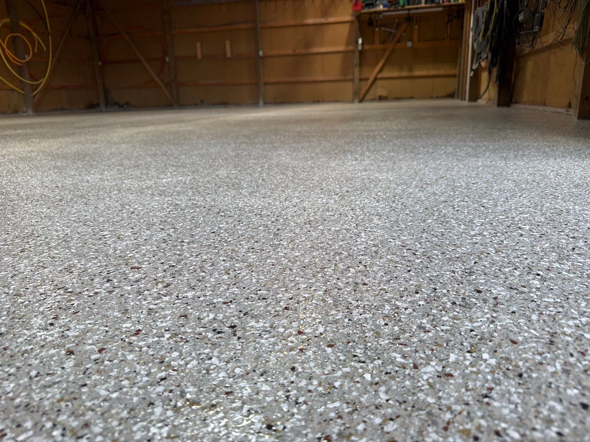 Polished concrete garage floor with exposed aggregate and smooth finish